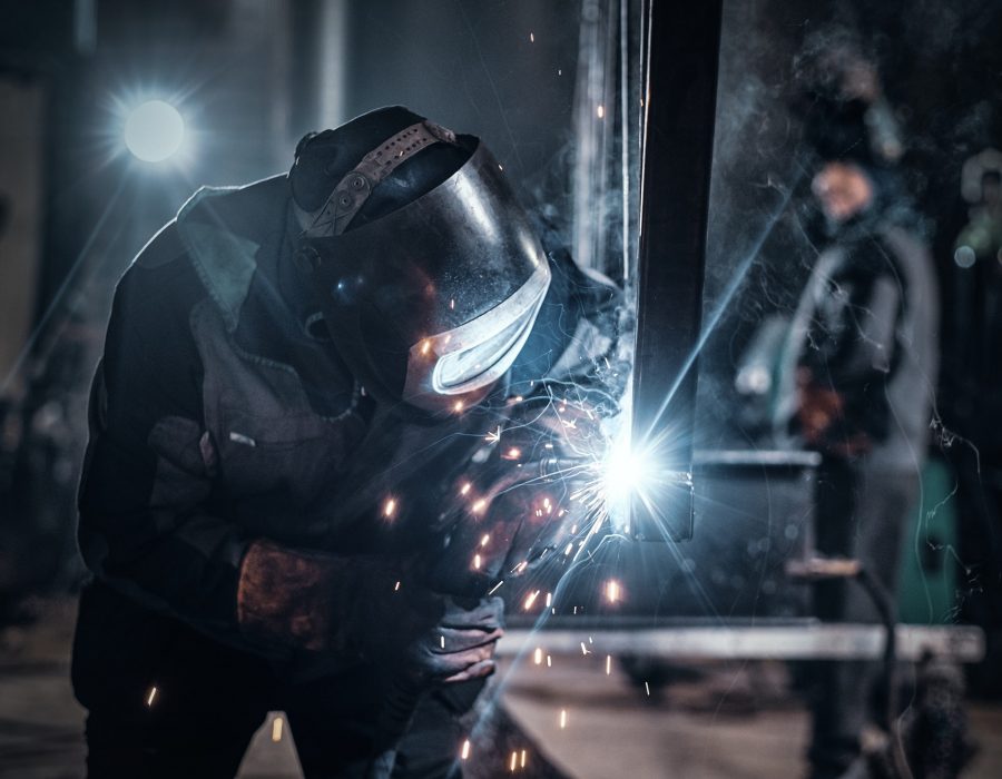 Man is working at the busy metal factory